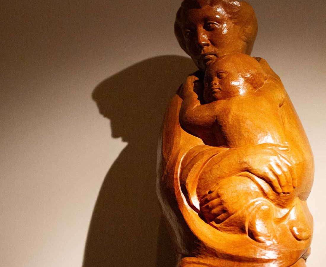 A statue of a mother holding a child.