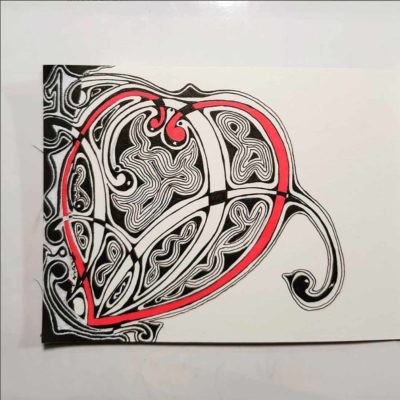 A calligraphy heart colored red.