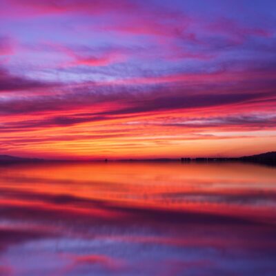 Red and purple sunset over water.